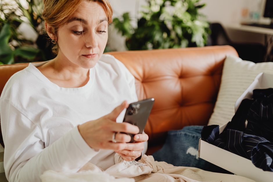 A patient filling out her intake form on her phone at home