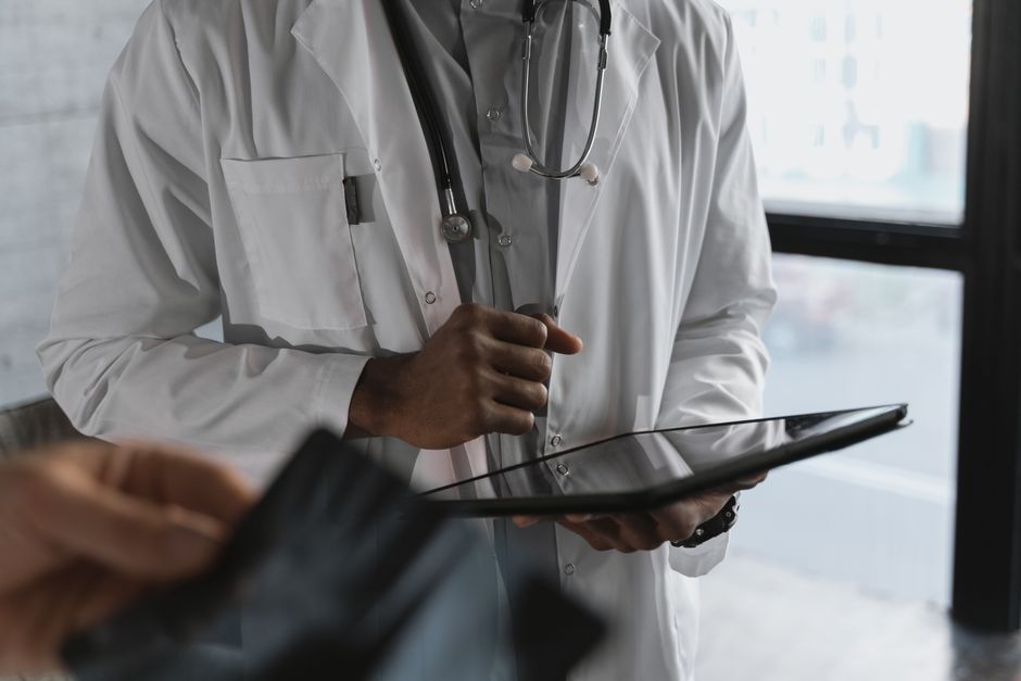 A doctor holding a tablet in a clinic
