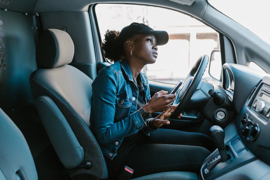 A patient in her car finishing a form before her appointment