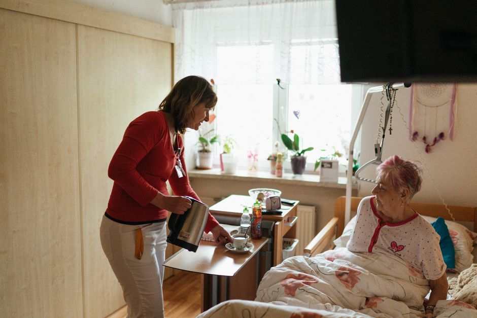 A caregiver helping a senior woman at home