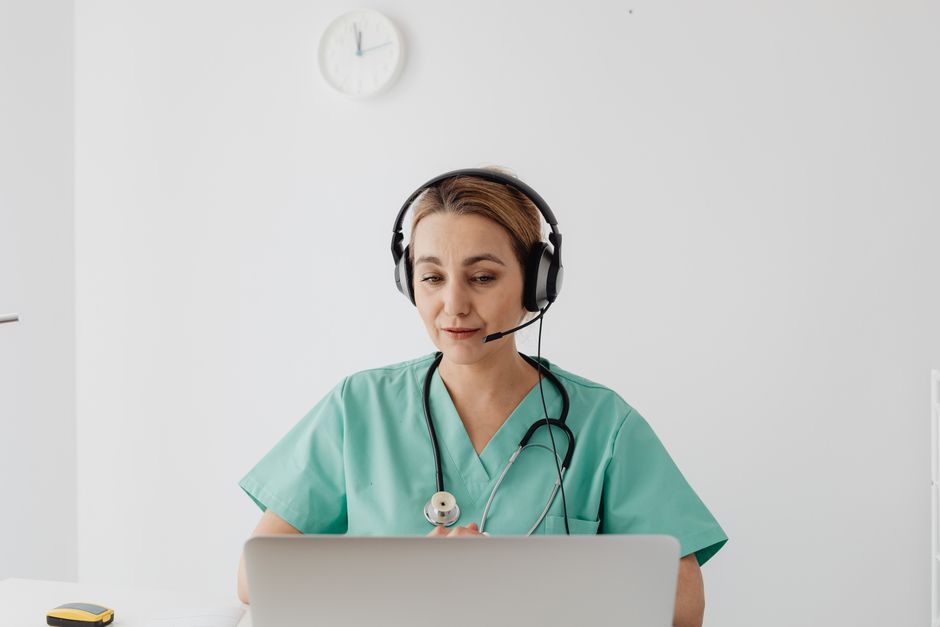 A clinician on a video consultation with a headset
